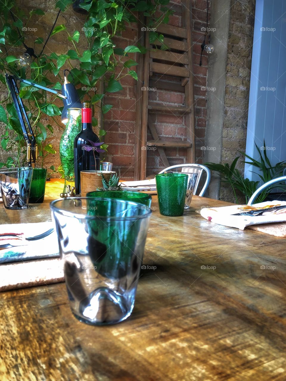 Supper club rustic table settings in loft with autumnal afternoon sunlight