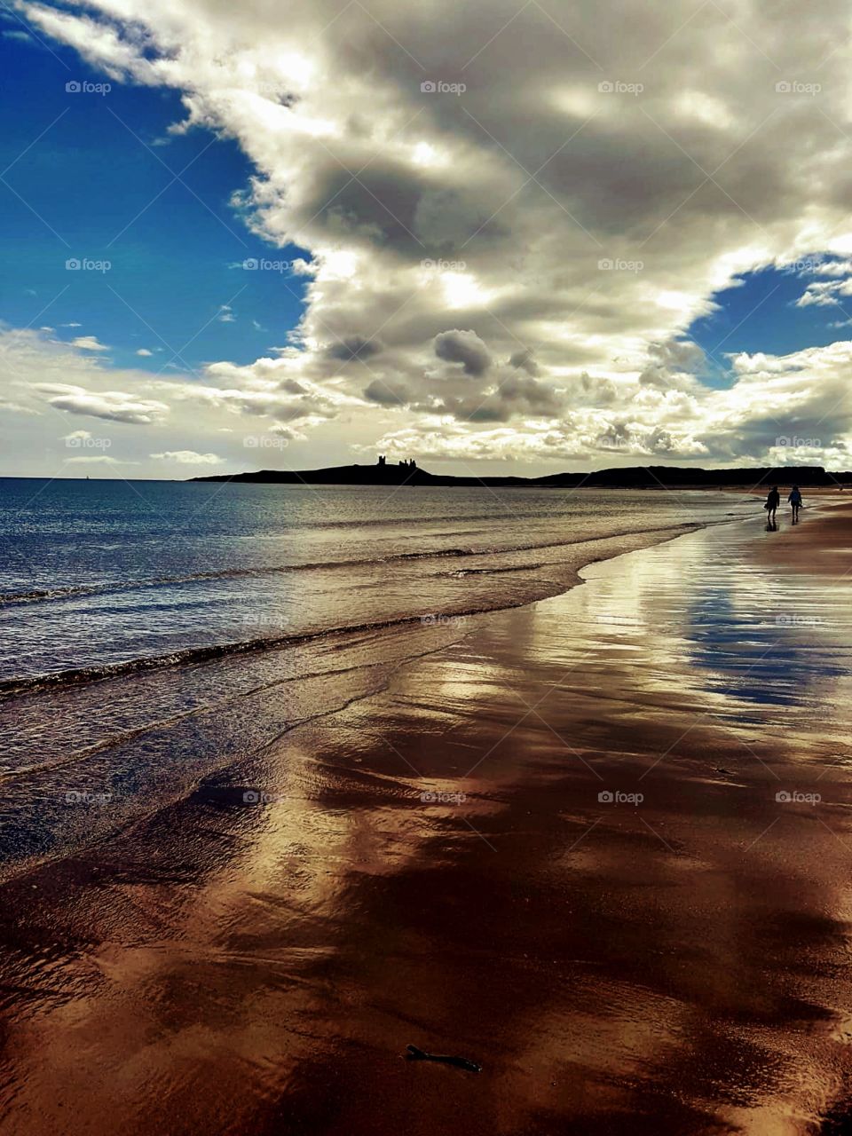 Seaside walk along Northumberland beach with colourful reflections
