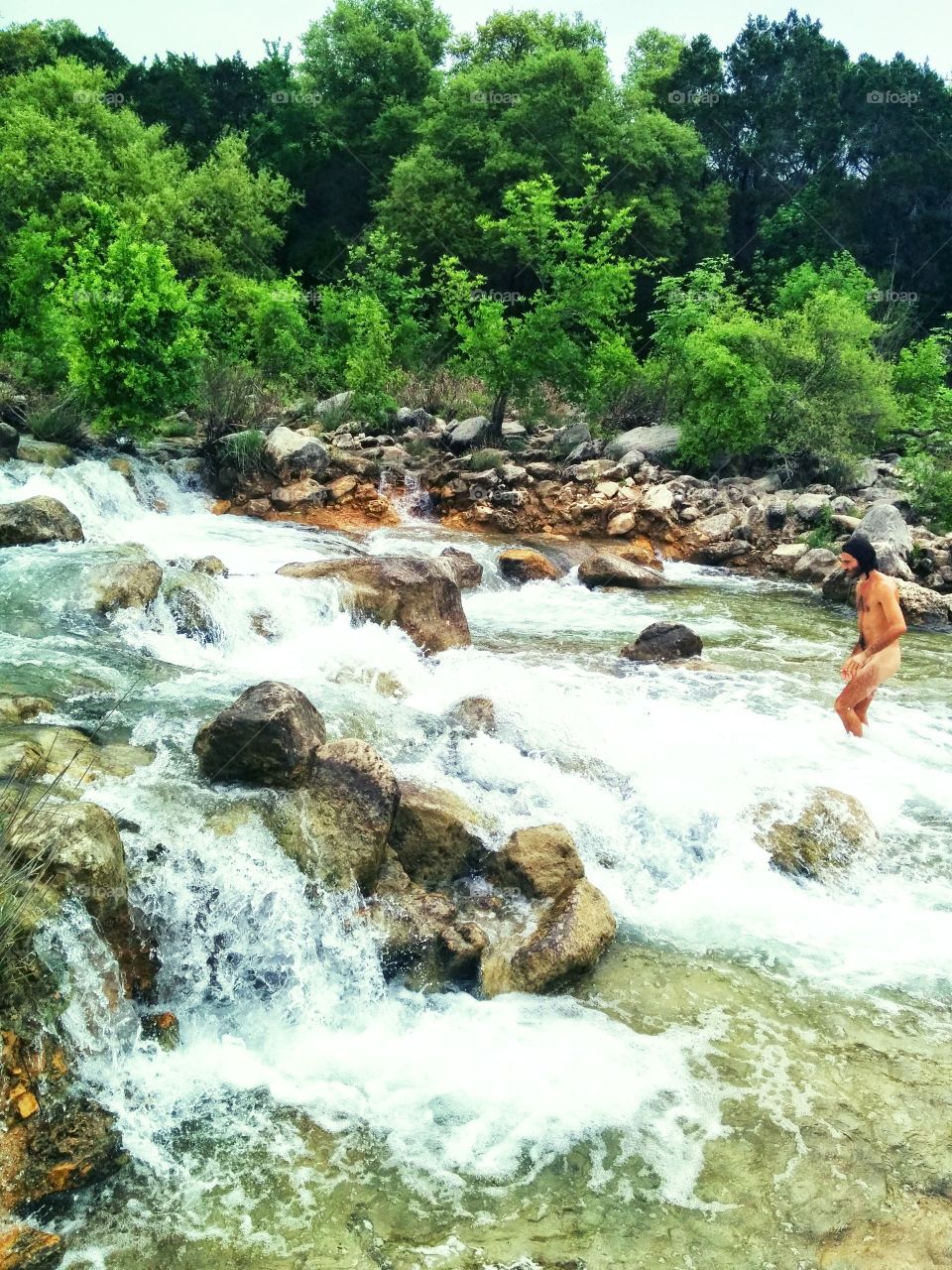 man in water. my love swimming at the greenbelt in ATX