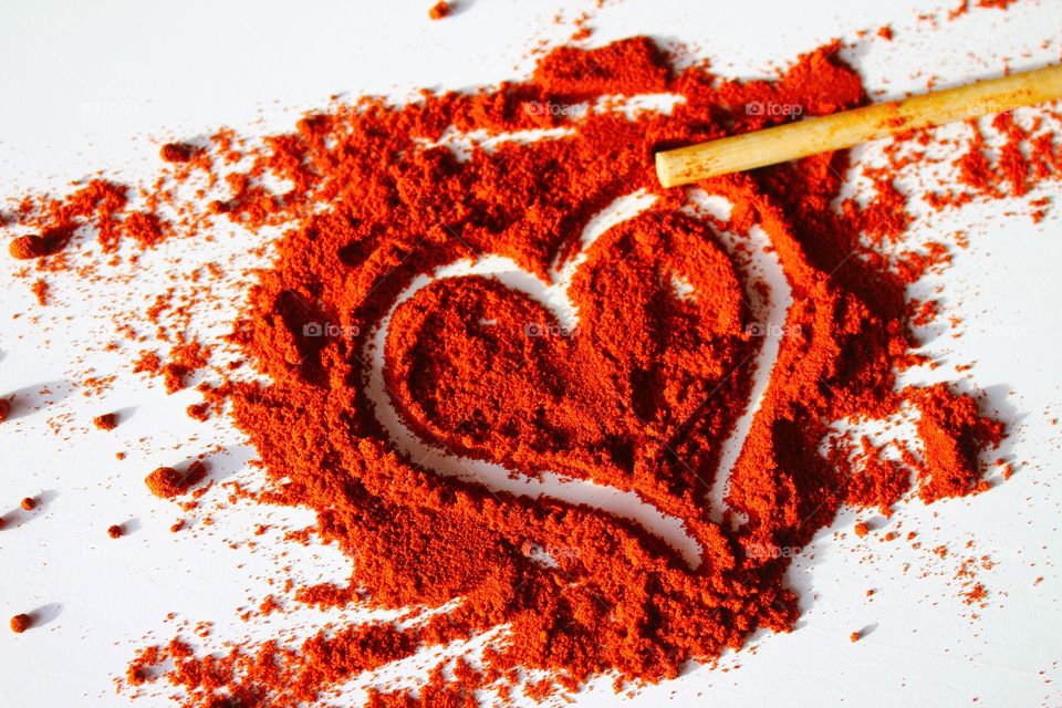 High angle view of heart shape paprika powder