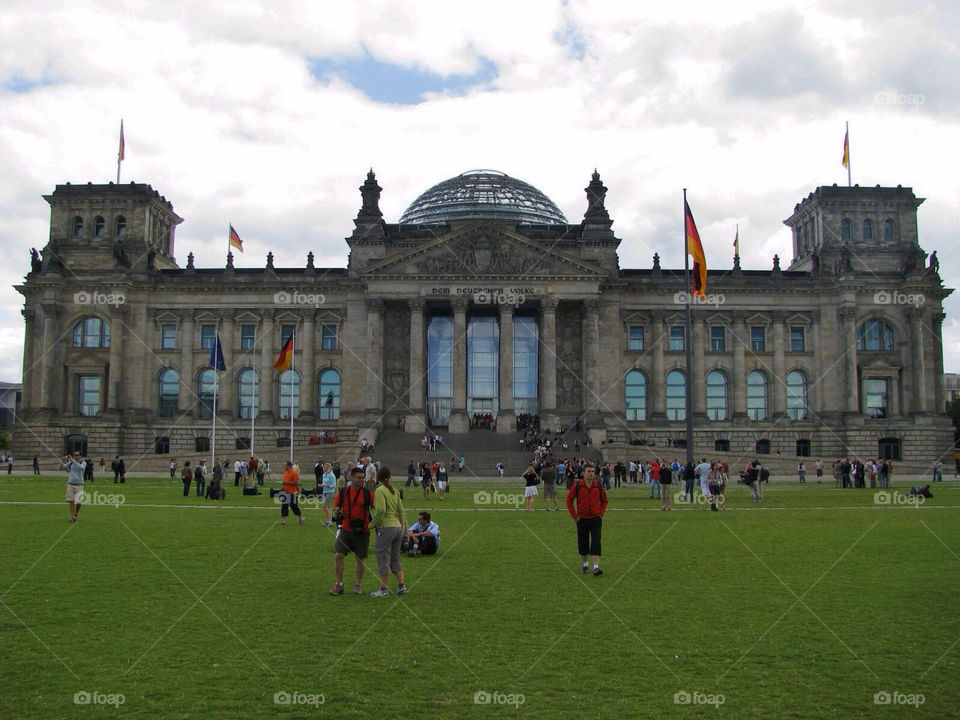 Reichstag in Berlin. Reichstag in Berlin with people relaxing in the grass. 