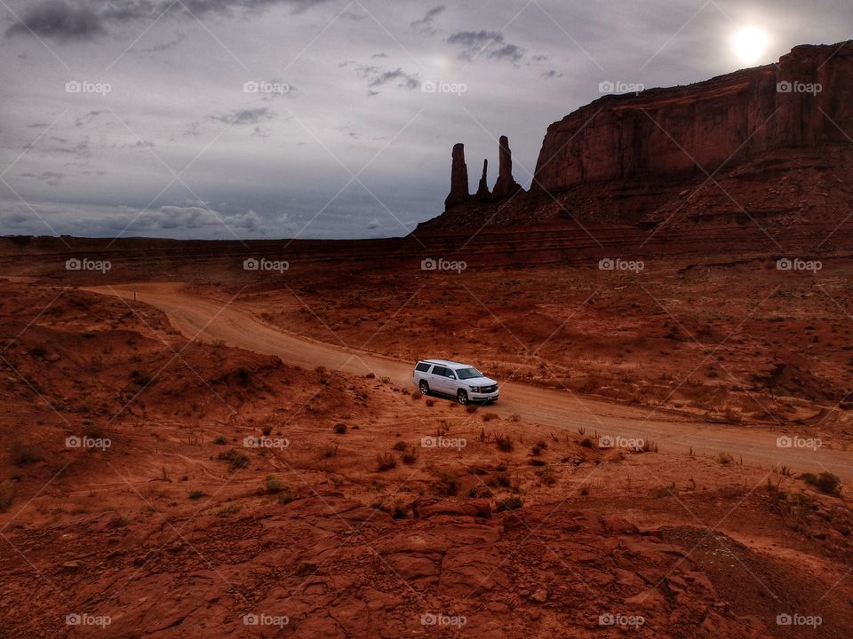 Malik drive.
This is Monument Valley in Utah. Magnificent spot. You may have so many good shots out there. I climbed on a hill and noticed that car driving. This red color of la d and a white car are contrasting pretty well.