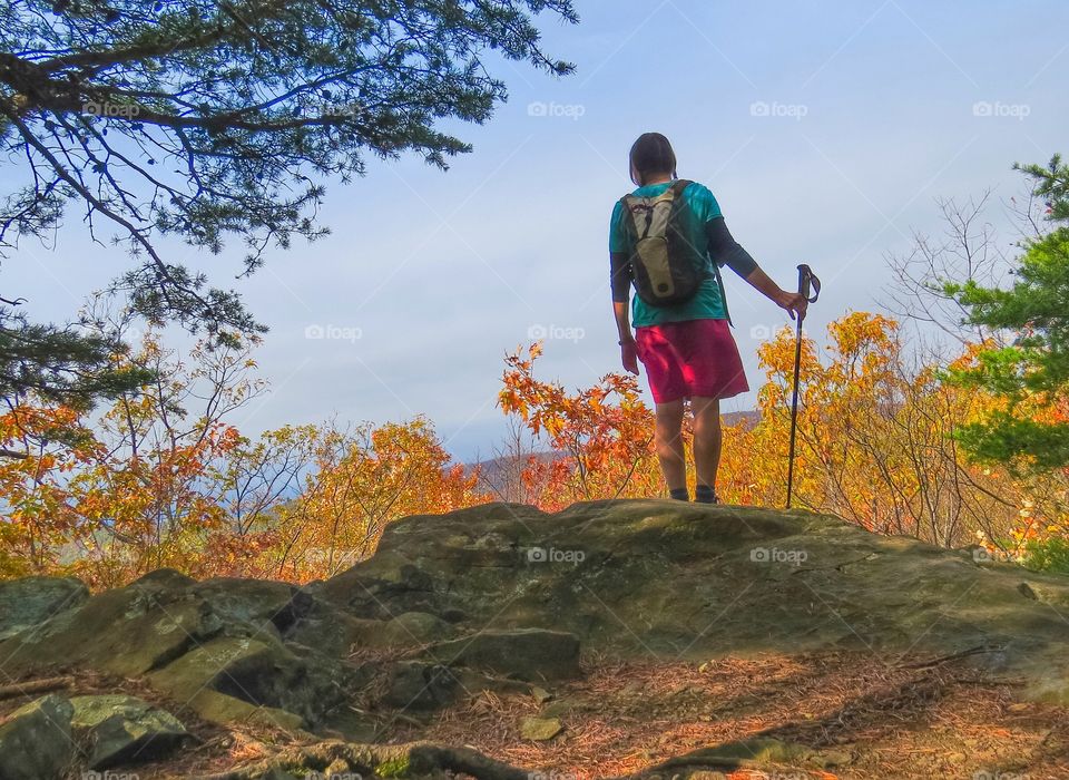 Hiker looking off towards the mountains in the Autumn.