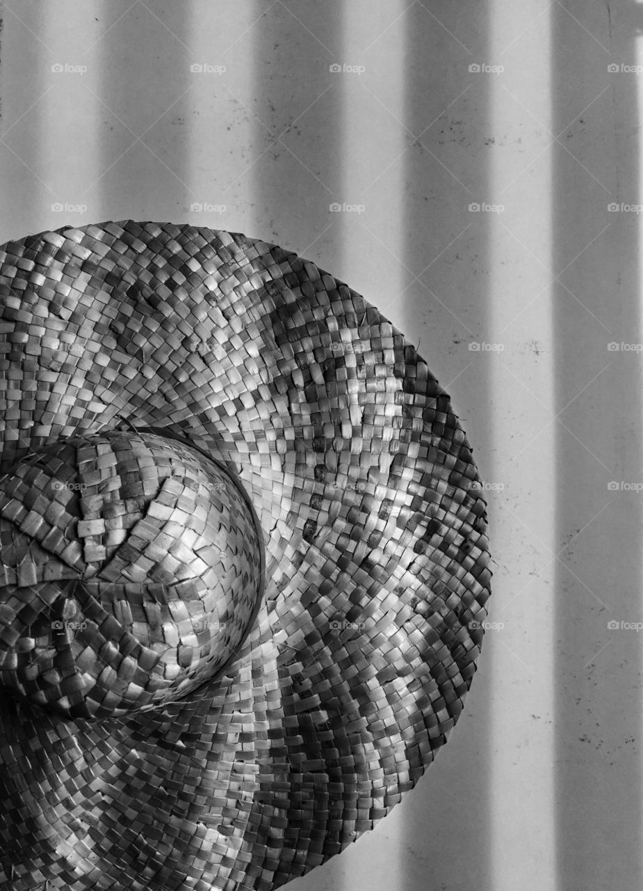 Fence shadows on native hat