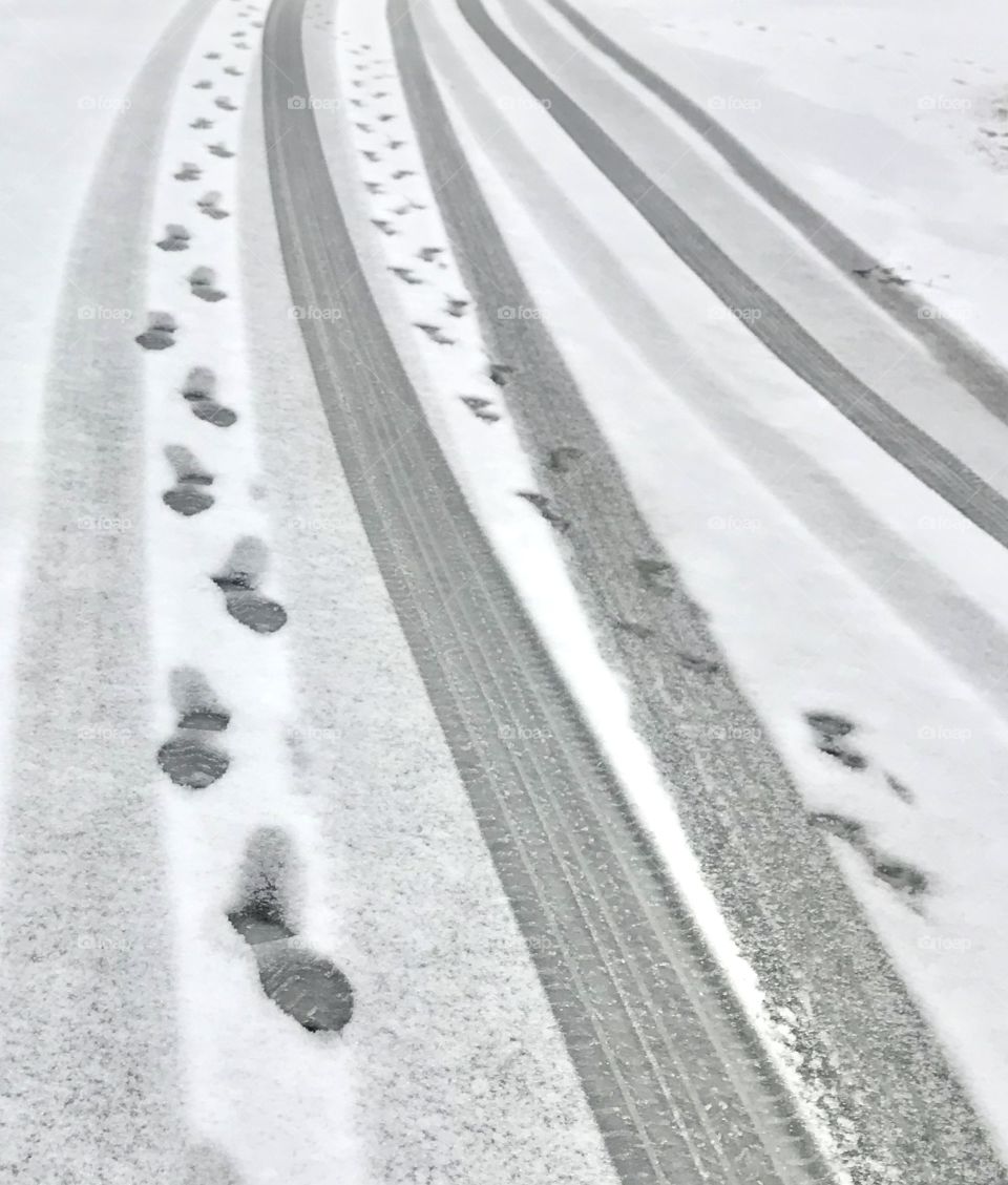 First signs of winter, tire tracks and foot prints in the snow