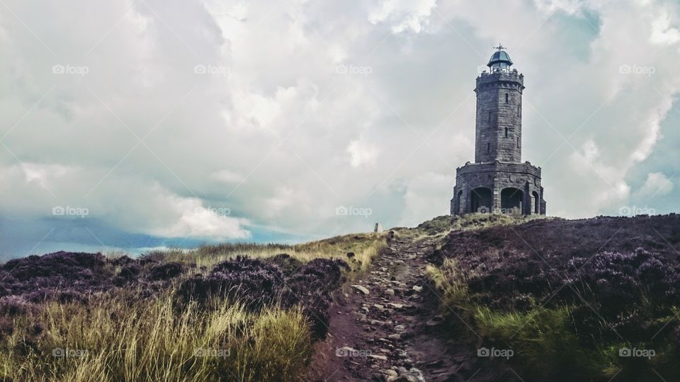 Cloudy sky over Darwen tower on hill