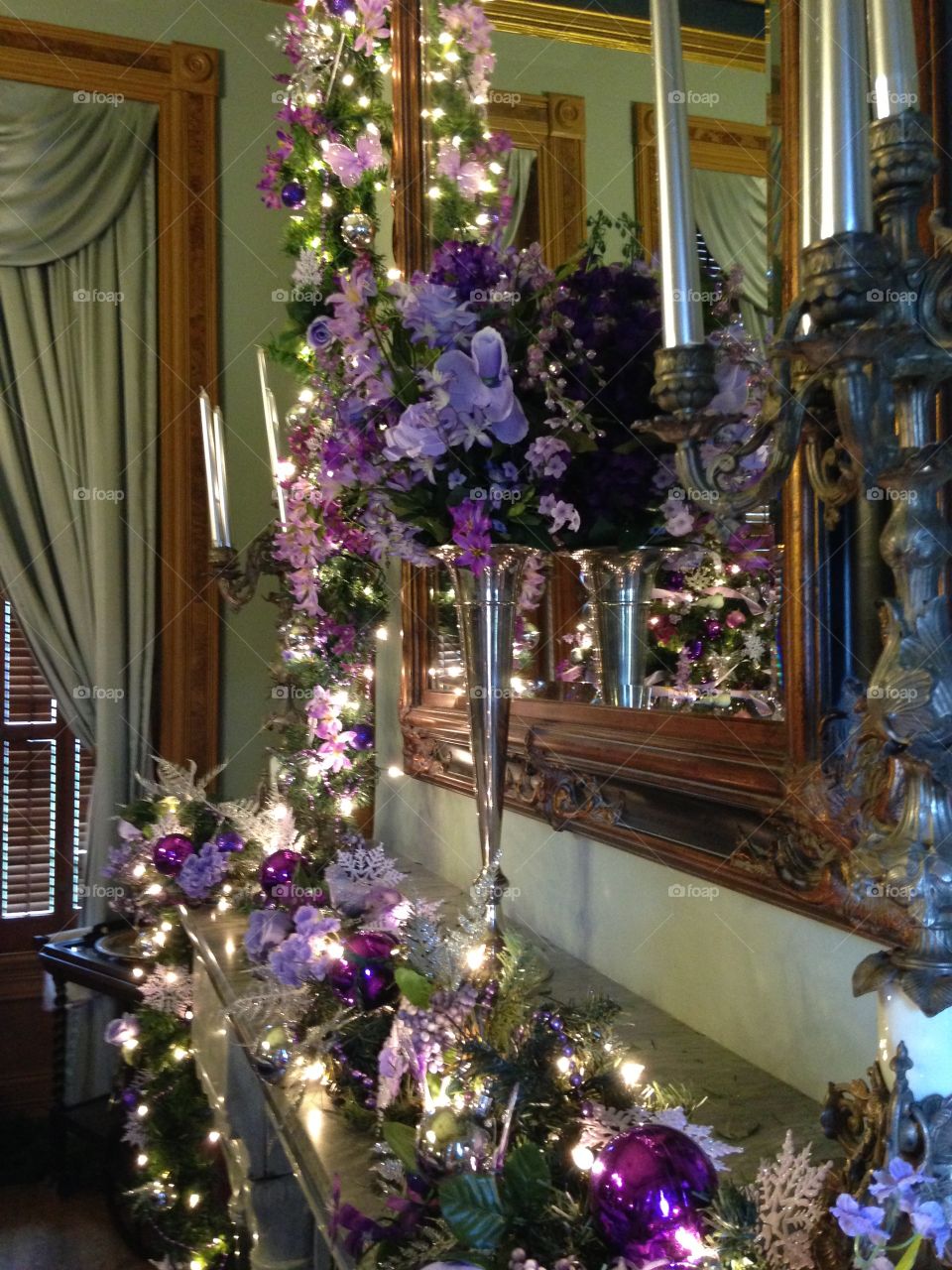 Fireplace decorated in a purple and sage holiday theme