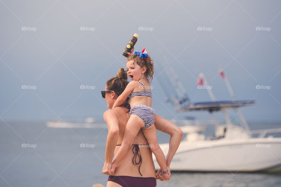 Summer fun with suntan lotion and piggy back rides