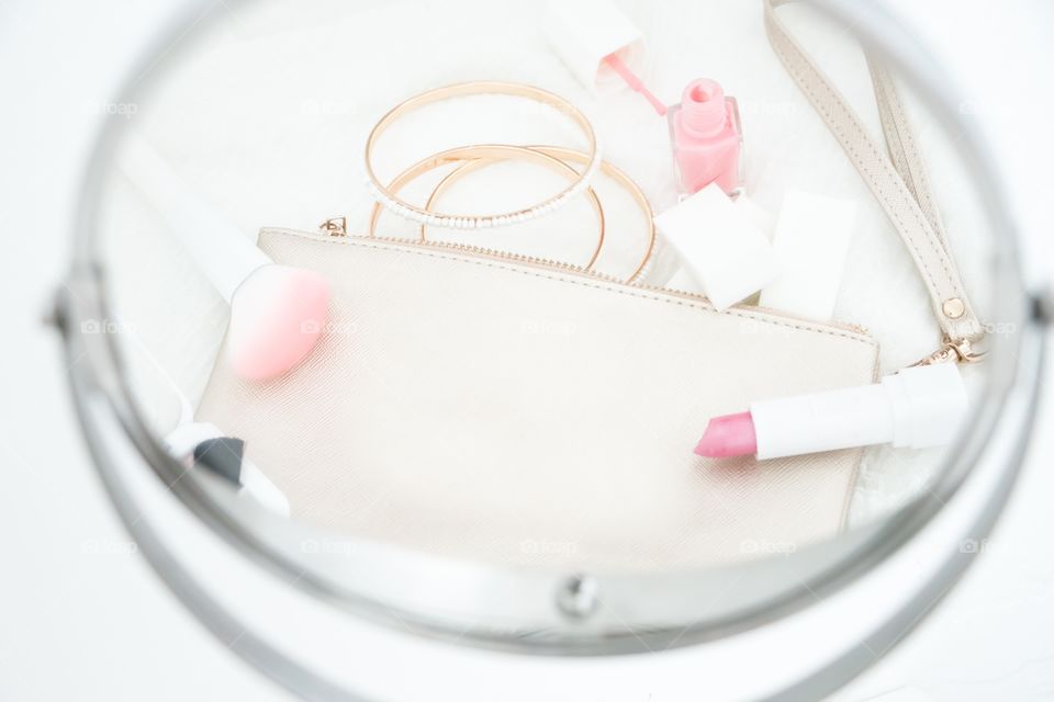 Flatlay with beauty items and wristlet 