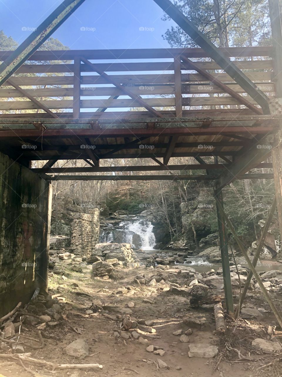 A bridge over a creek in southern Georgia Park on a beautiful day. 