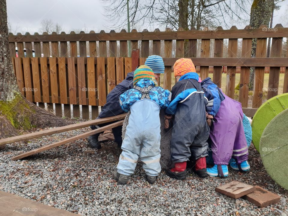 Small children playing together in early spring in Sweden
