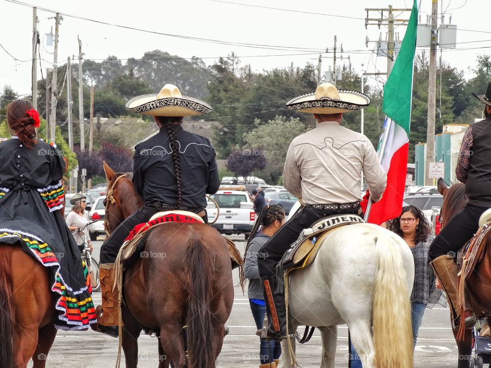 Mexican Horsemen. Cowboys Carrying Mexican Flag

