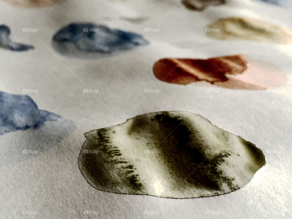 Watercolor pois on a white paper 