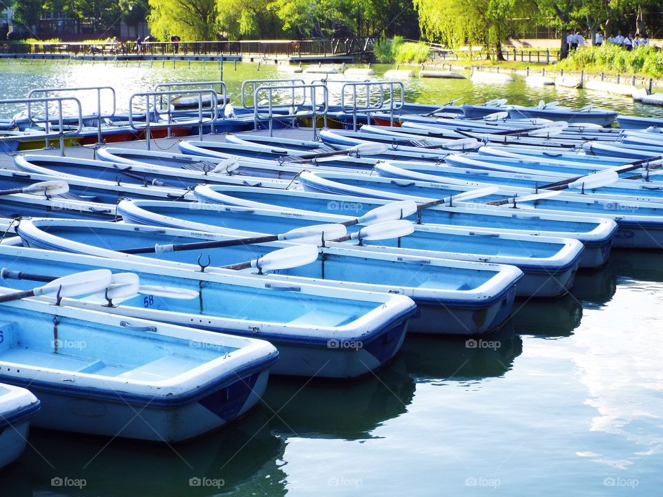 View of blue boats moored in lake