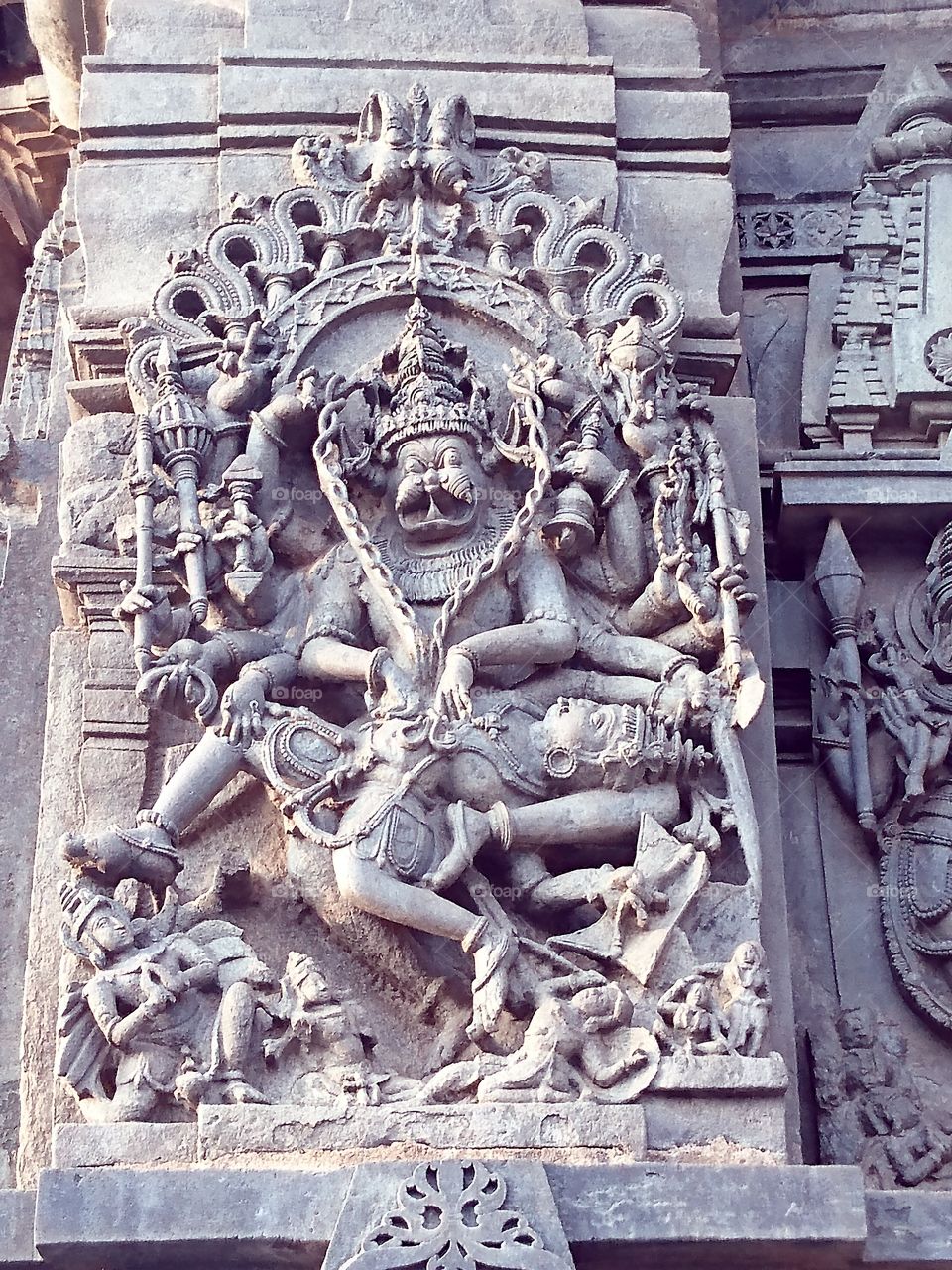 Belur Chennakeshava temple - Lord Narasimha killing the demon Hiranya Kashipu - demon intestines pulled out from the body using upper hands