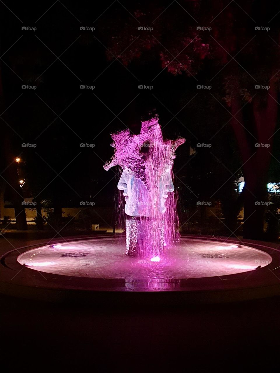 Fountain with two faces in purple colours 