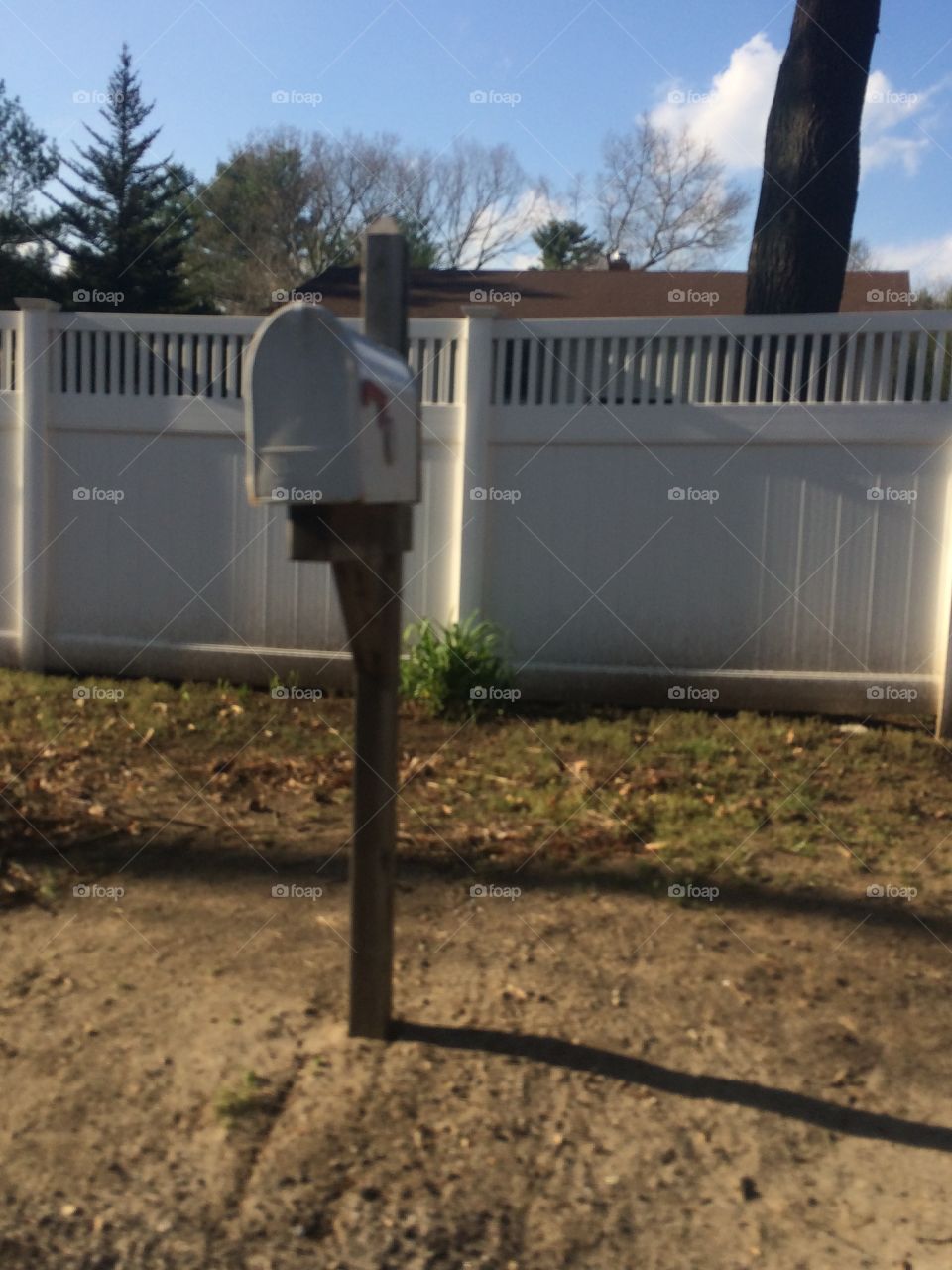A random white picket fence with the mailbox. Modern middle class. 