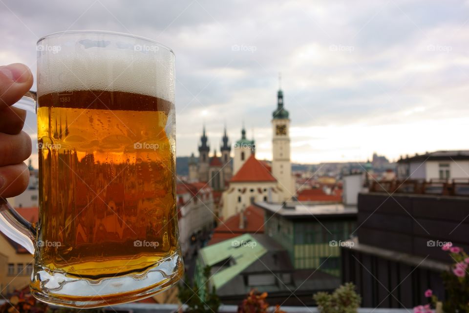 Pint of Czech beer in Prague. A fresh pint of Czech craft beer on a rooftop terrace in the center Prague, Czech Republic.