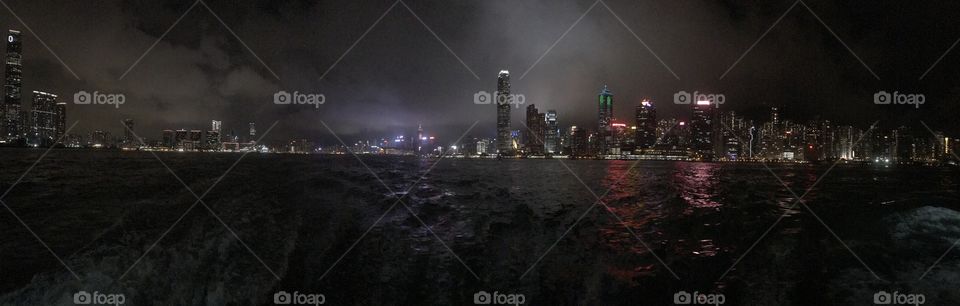 The Hong Kong Skyline on a moody evening. Taken from the back of a ferry headed towards Lantau Island. 
