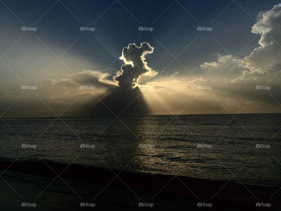 This was captured by an early sunrise showing the sun rays coming through the clouds creating lady with her hair up and her elegant long gown formed by the clouds