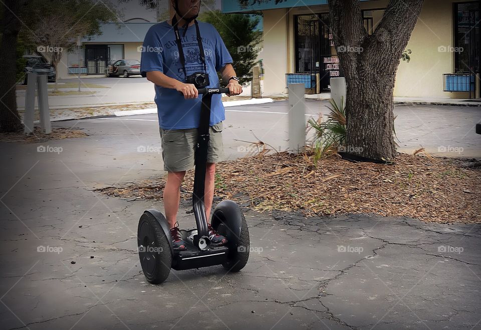 Man traveling with ease on a Segway transportation system.