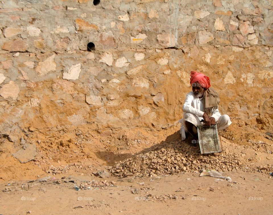 Laborer in India. A worker takes a short break in India