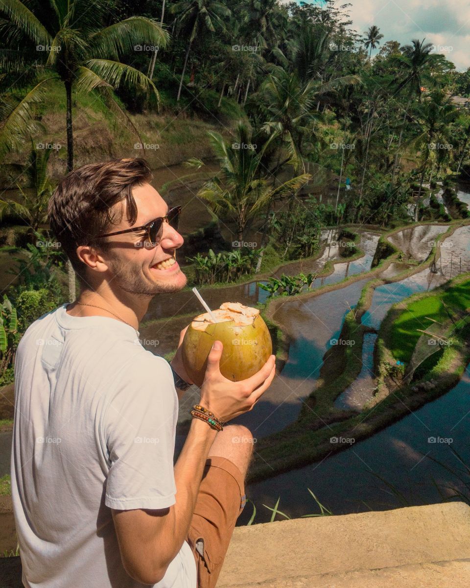 Man sipping a coconut in Ubud, Bali. 