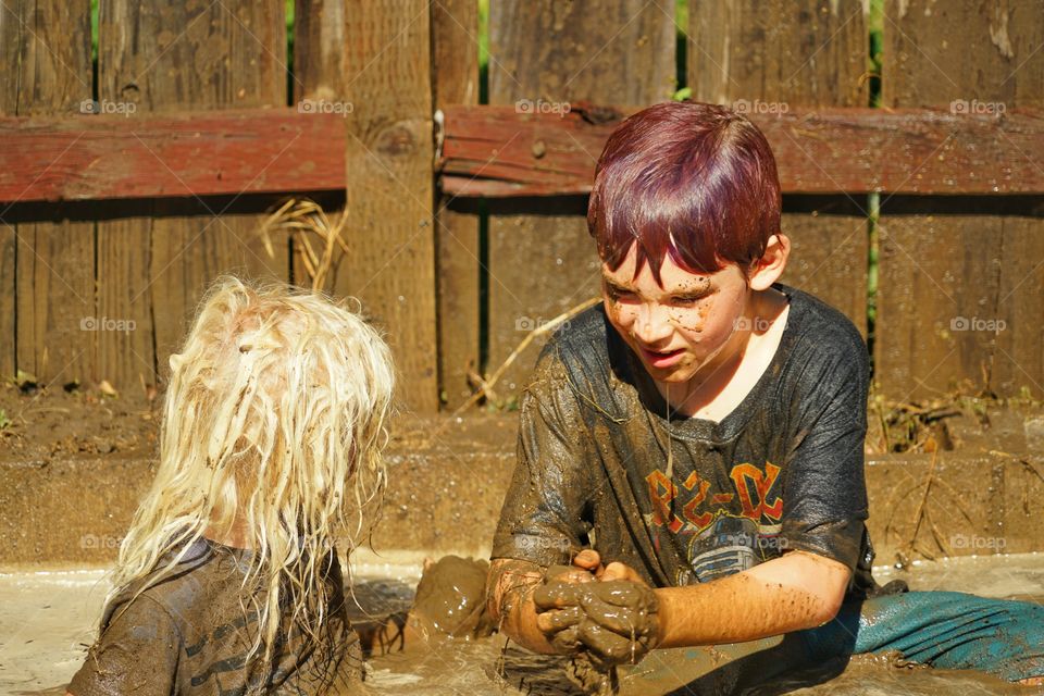 Kids Playing In Mud