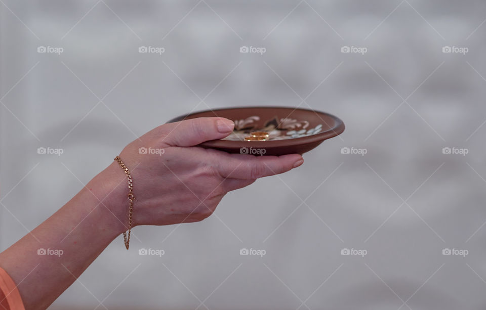 Close-up of a woman's hand with wedding rings