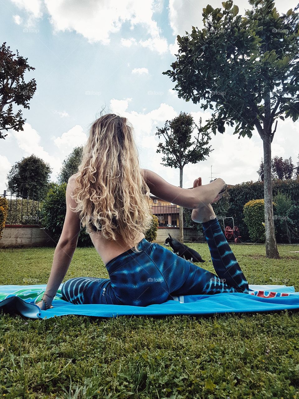 Yoga girl in the garden with dog