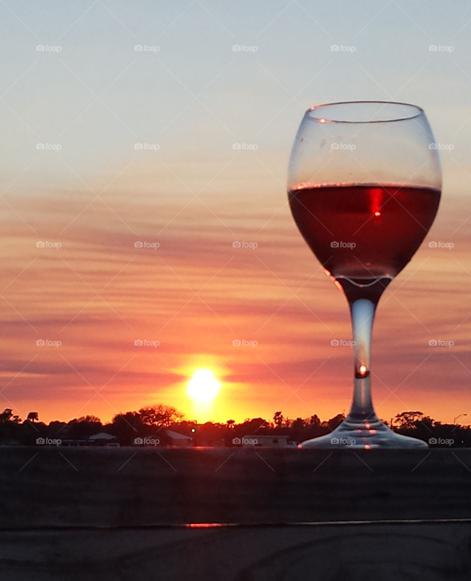 a glass of wine in the sunset
