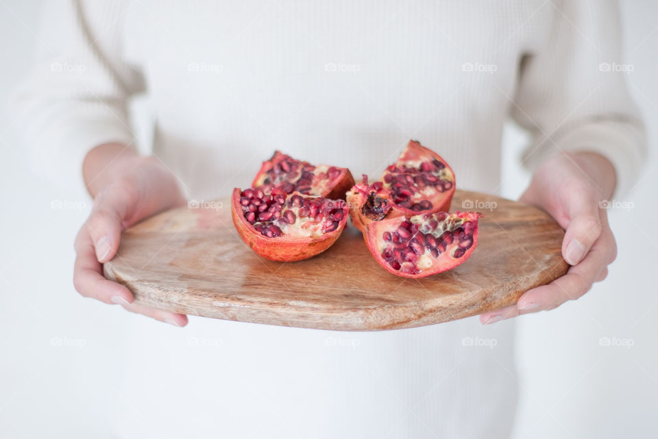 Girl holding red pomegranate