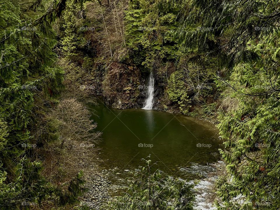 View of a waterfall from the Cliffwalk at Capilano Suspension Bridge Park in North Vancouver British Columbia