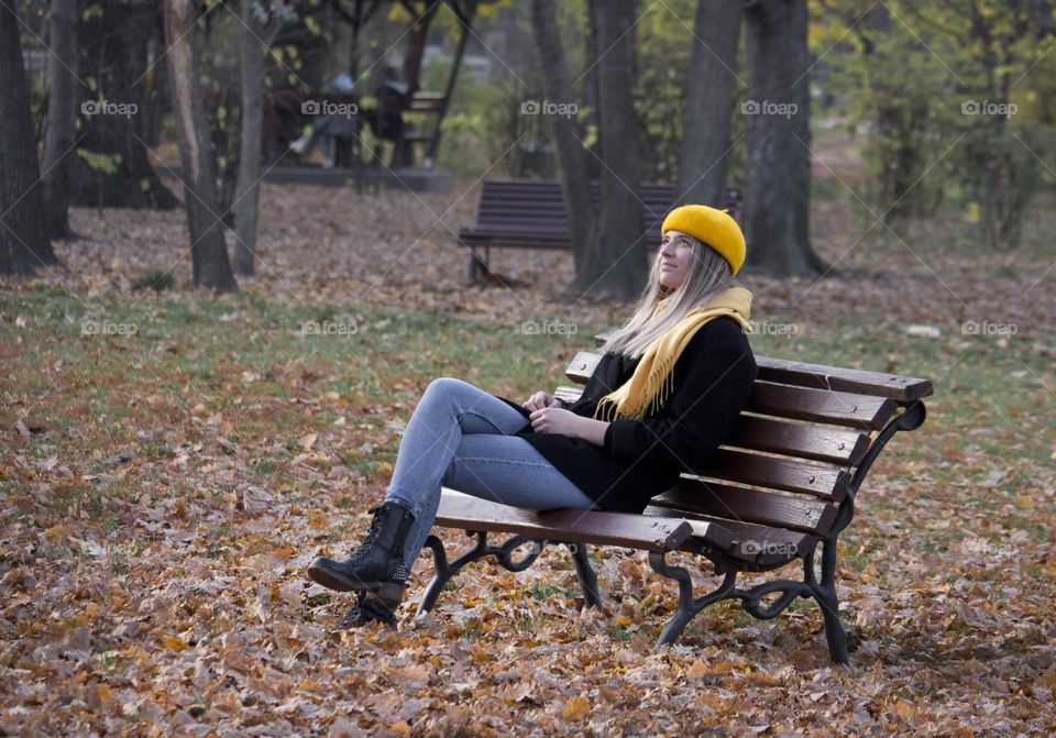 A woman at the bench in the park