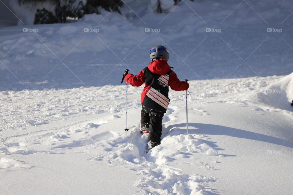 Boy walks in deep snow 