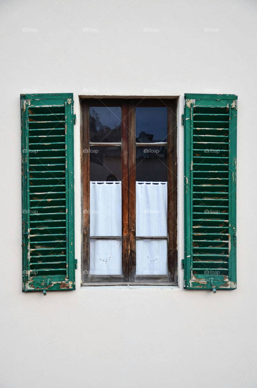 A nice wooden window with shutter. This is an exterior of small hotel in Montecatini-Terme, Italy.