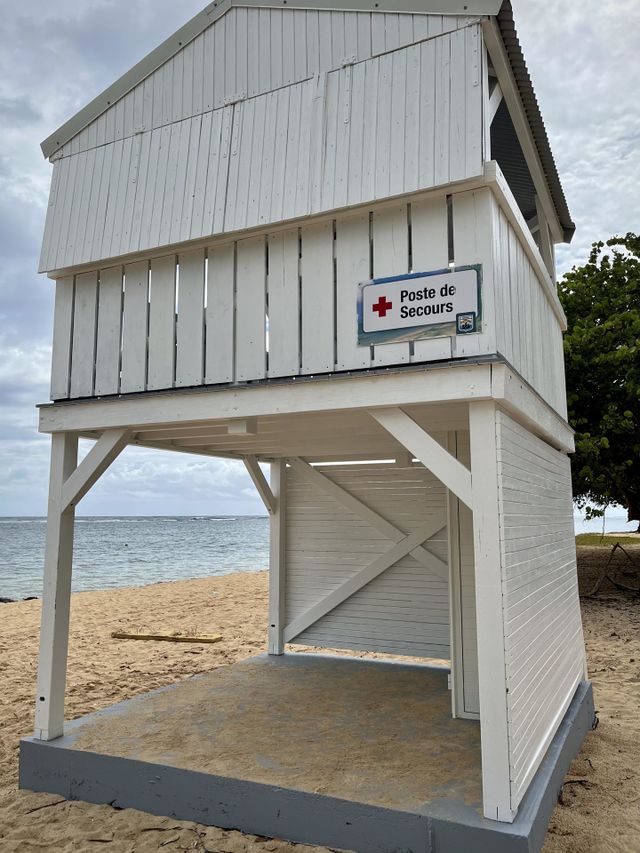 White wooden emergency cabin on a Caribbean sandy beach