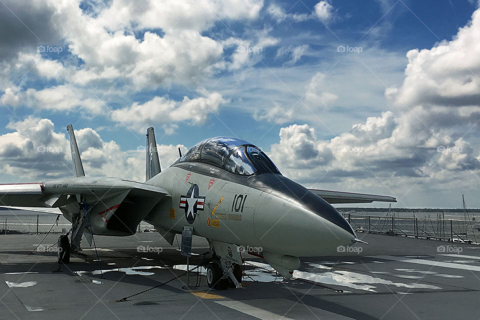 F14 fighter jet on aircraft carrier with sky