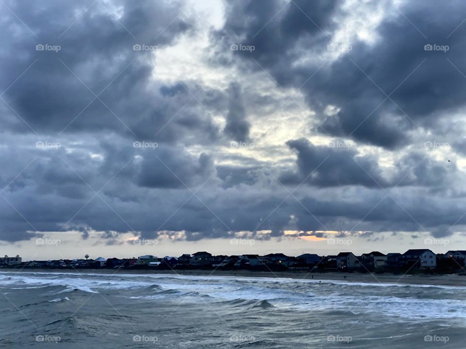Storm clouds moving in along the Atlantic Ocean at sunset