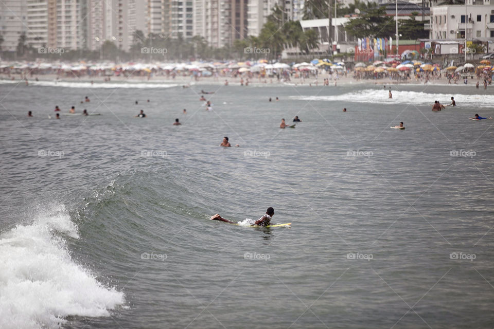 Surfer catches wave on the beach Guarujá, Brazil