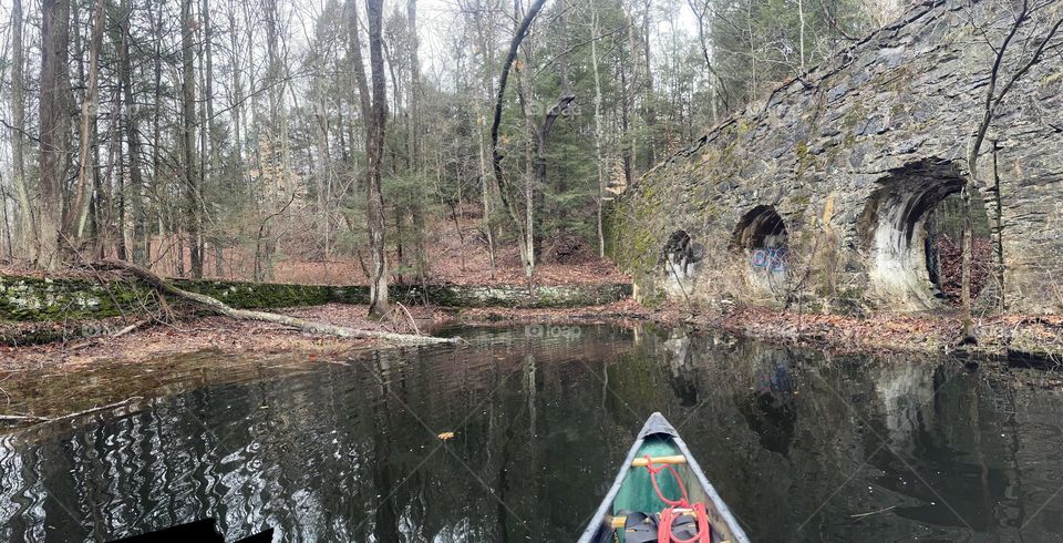 Canoe bow pointed at ruins of old hydro dam