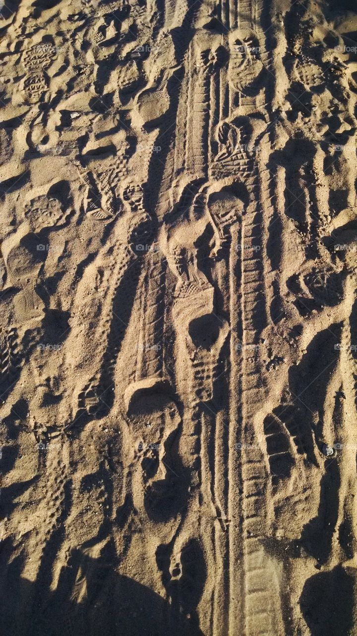 Foot And Tire Prints Sand