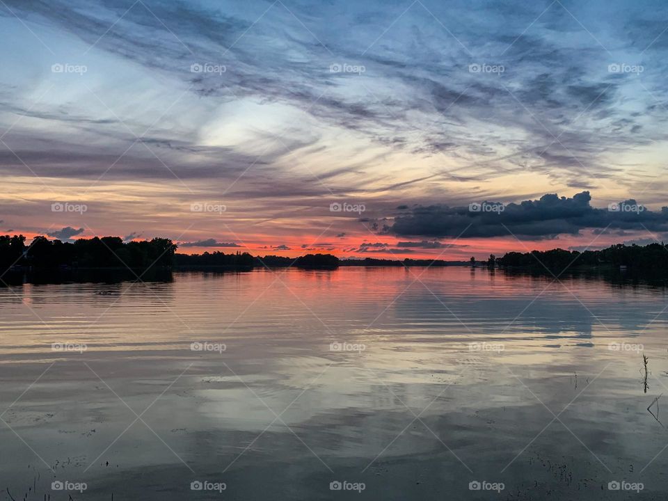 Sunset reflection on calm lake 