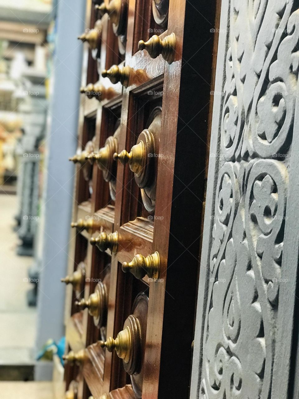 A temple door with great multiverse design and poles 