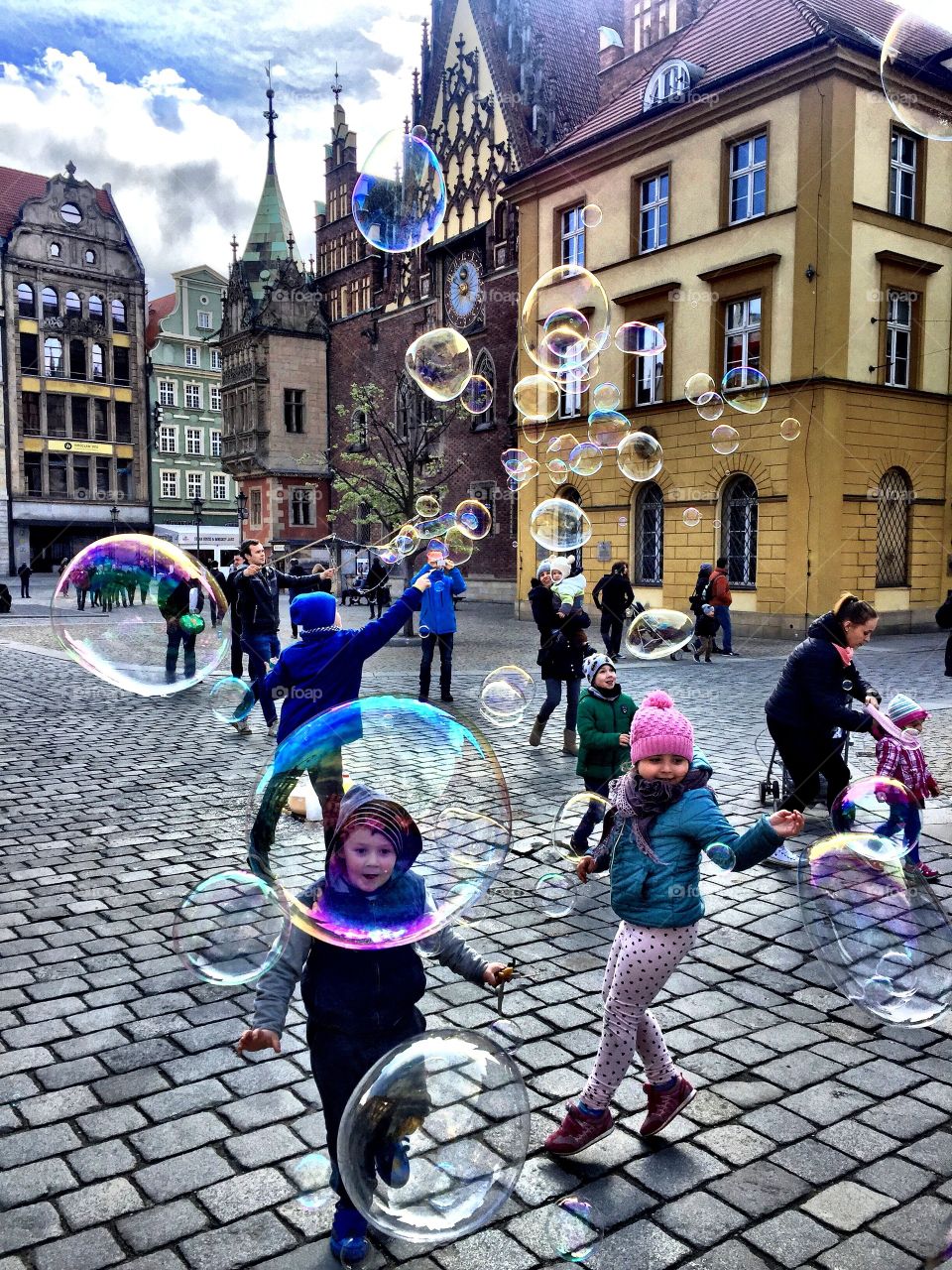 Children playing with bubble on street