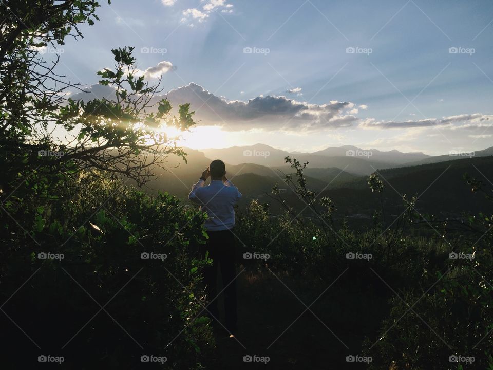 Man taking photo in forest