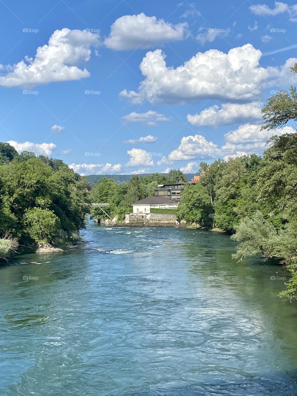 View from the bridge on the river and the cloudy sky