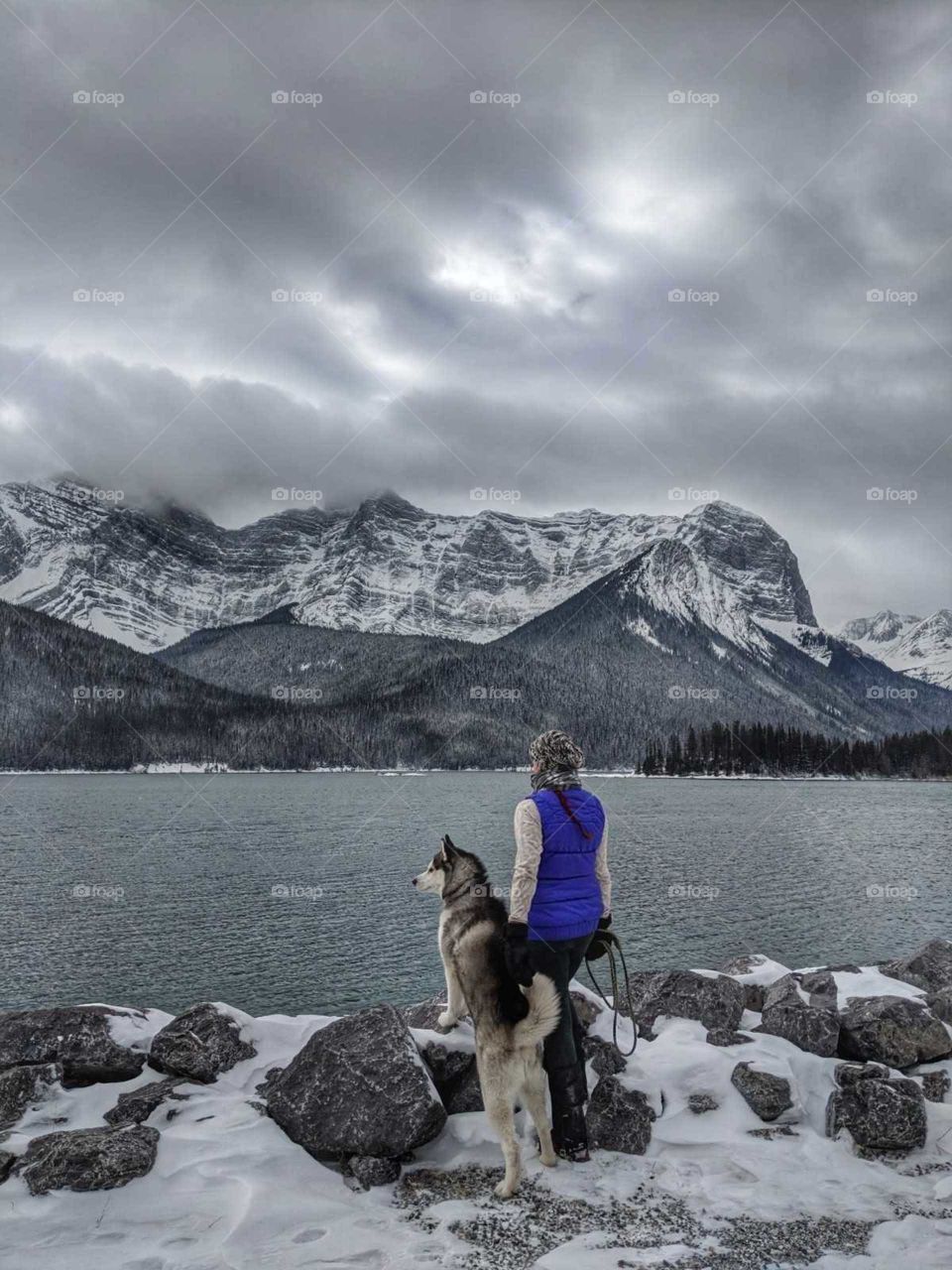 A girl and her wolf by the frozen waters