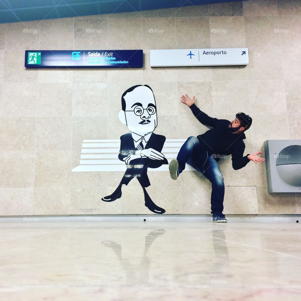 A beard man scared from painted picture in the airport subway
