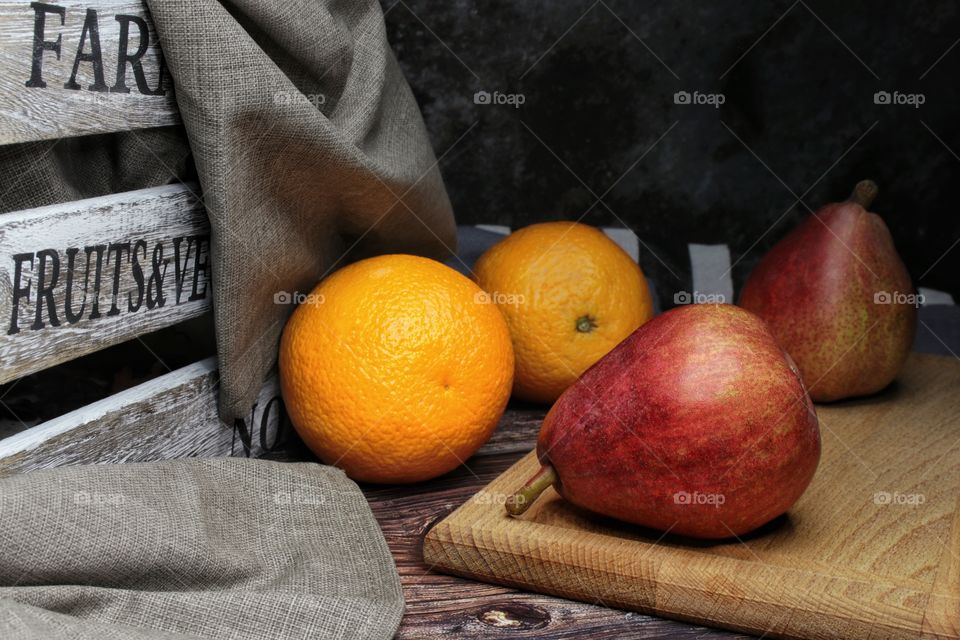 Still life of pears and oranges on the table